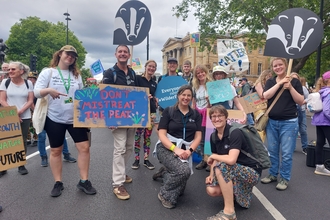 Group of DWT staff and supporters holding placards on road