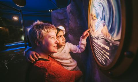 Child reading information at Seaton Jurassic