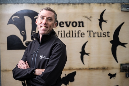 Nick Bruce-White in front of Devon Wildlife Trust sign